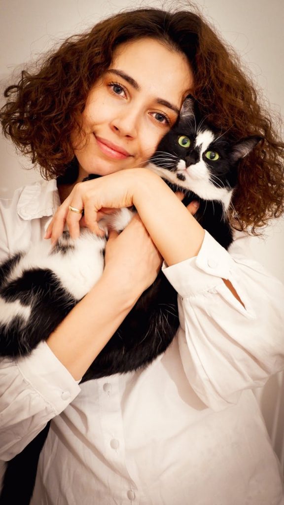 woman posing for portrait with cat